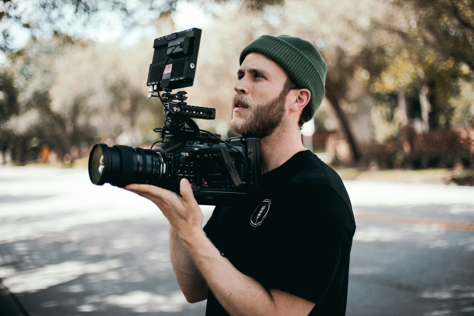 Creator holding a video camera ready to film YouTube content