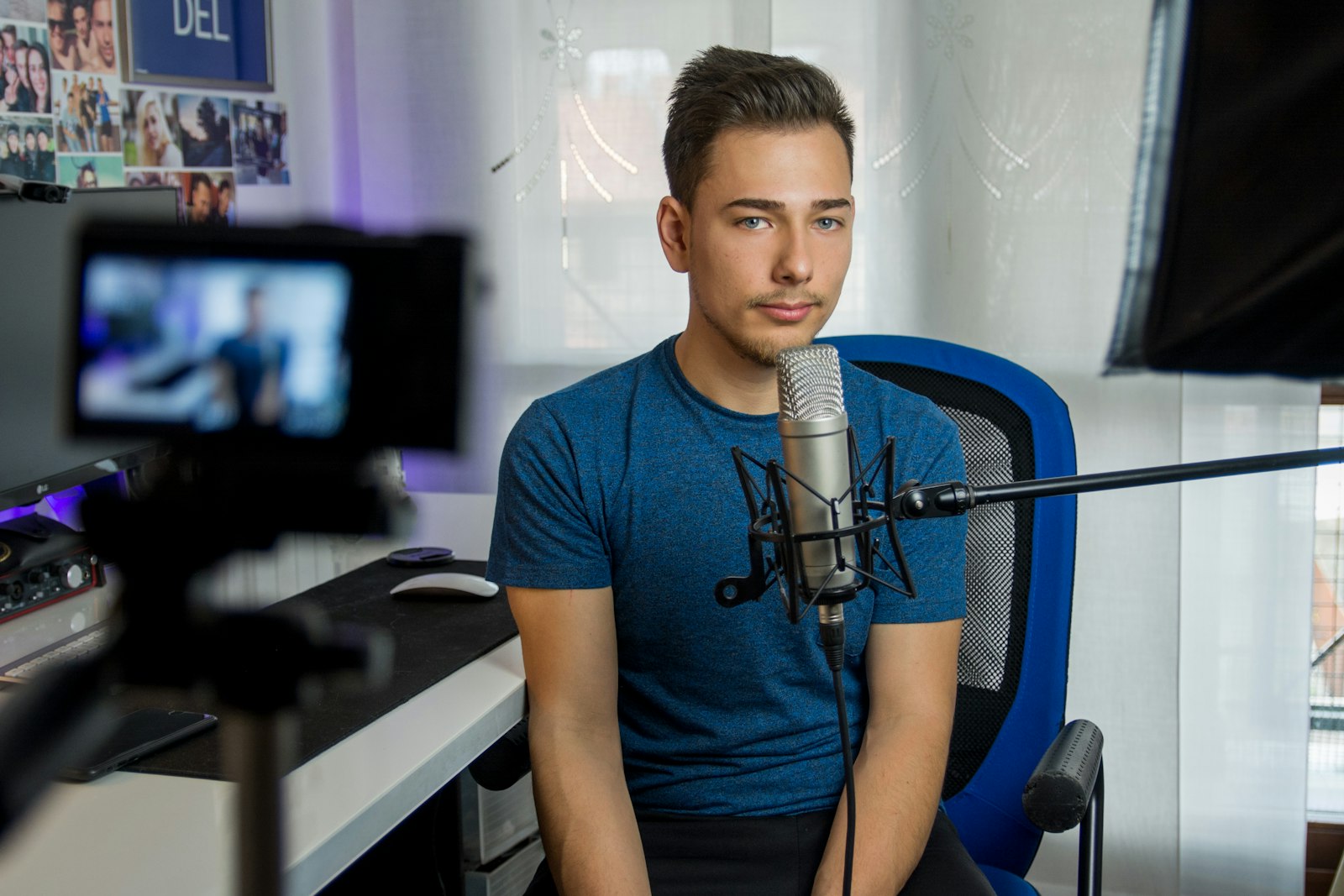 YouTube creator at a condenser microphone in a home studio